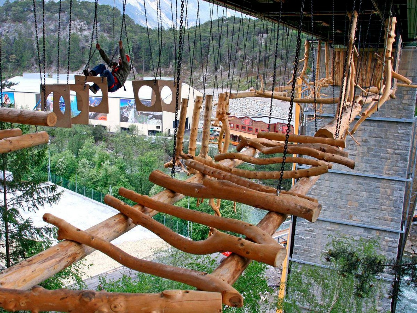 A high ropes course with wooden bridges and obstacles — an exciting adventure for all ages in the Tyrolean Alps.
